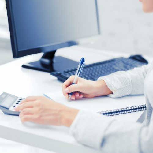 businesswoman with notebook and calculator